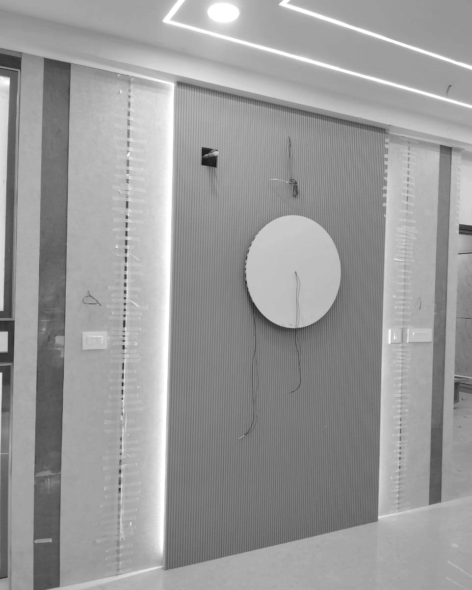 Feature wall with inlay strips held by tape while the adhesive sets