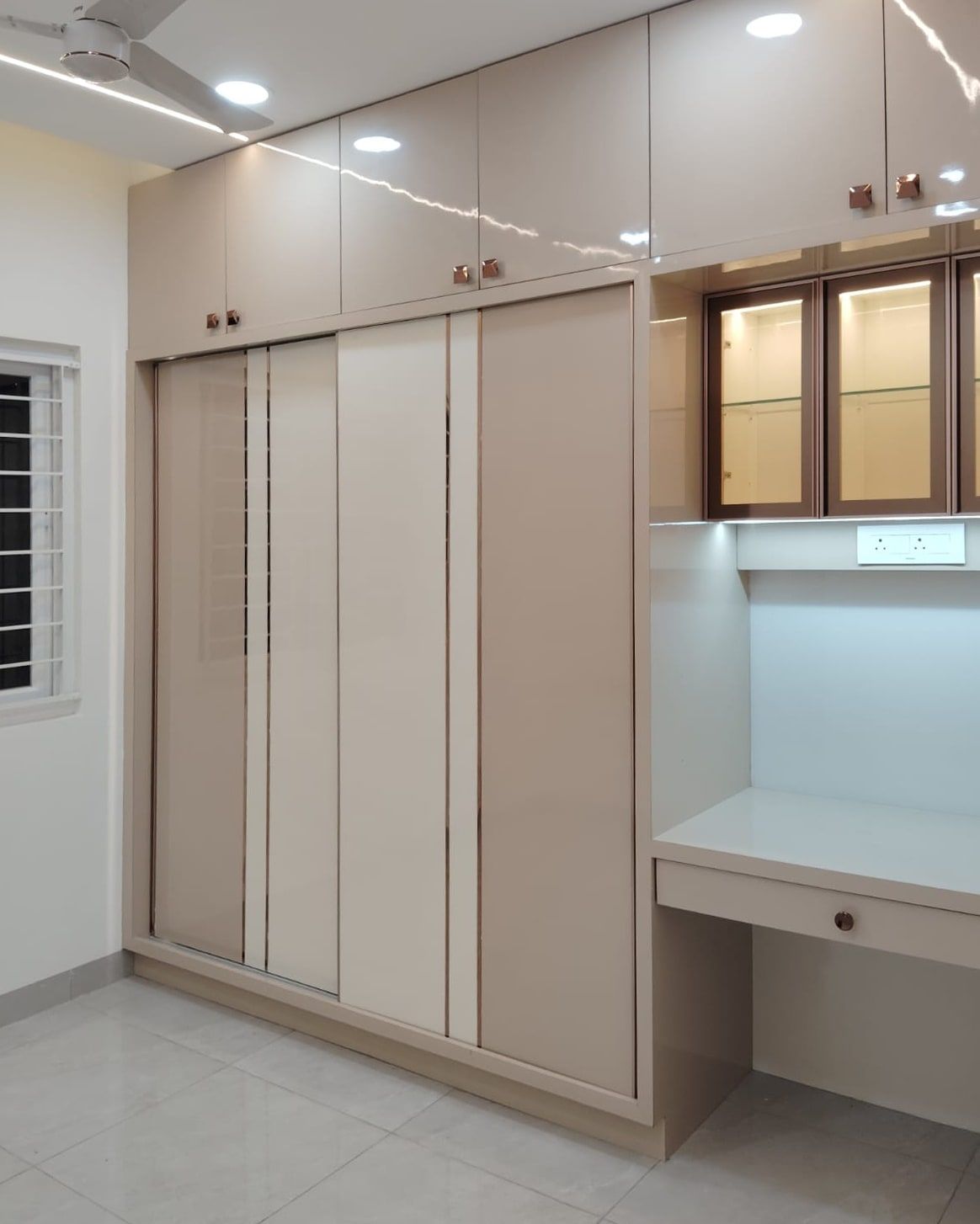 Champagne wardrobe with inlay lines and a lit glass study unit