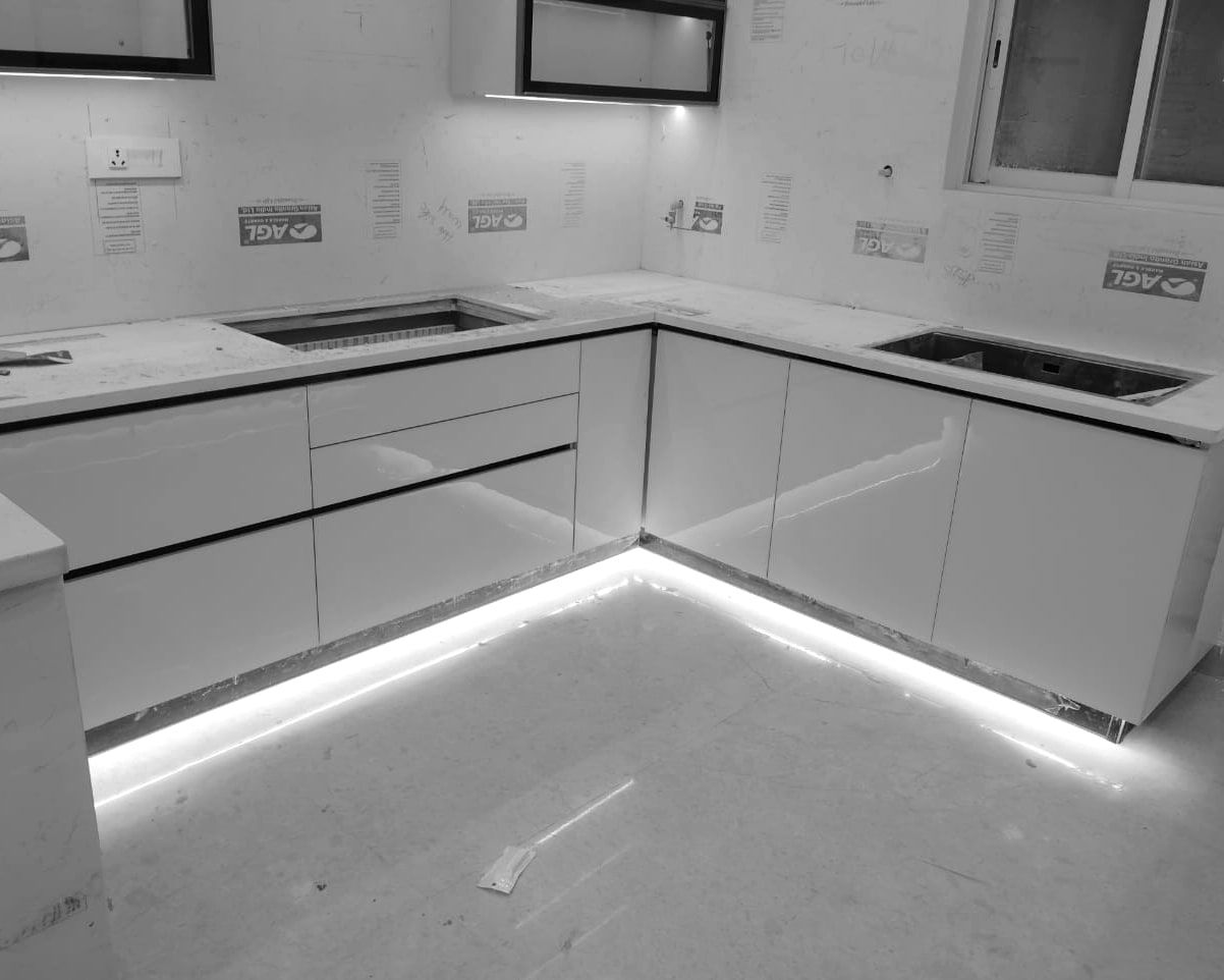 The same kitchen from the other side, plinth light on, labels still on the tiles