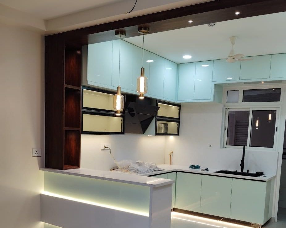 The finished kitchen with pendants lit over a backlit counter